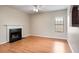 Living room showcasing a fireplace, hardwood floors, and a ceiling fan at 11151 Aliyah Dr, Hampton, GA 30228