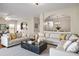 Stylish living room featuring modern furniture, neutral tones, and a view into the dining area at 11151 Aliyah Dr, Hampton, GA 30228
