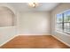 Bright and airy living area with hardwood floors, complemented by a large window for natural light at 11151 Aliyah Dr, Hampton, GA 30228
