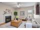 Cozy living room with fireplace, hardwood floors, and comfortable seating area at 11151 Aliyah Dr, Hampton, GA 30228