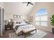 Beautiful main bedroom with a vaulted ceiling, bench and an arched window at 11151 Aliyah Dr, Hampton, GA 30228
