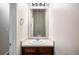 Cozy powder room with a vanity, sink, and mirror at 11151 Aliyah Dr, Hampton, GA 30228