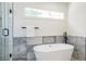 Bright bathroom showcasing a soaking tub with elegant fixtures and tiled accents at 1934 Westwood Sw Ave, Atlanta, GA 30310