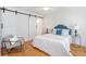 Bedroom with light hardwood floors, closet and a modern accent chair at 1934 Westwood Sw Ave, Atlanta, GA 30310