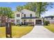 Inviting two-story home with a freshly painted exterior, charming front porch, and driveway at 1934 Westwood Sw Ave, Atlanta, GA 30310