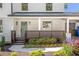 Welcoming front porch with stylish railings and meticulously landscaped garden, beautiful entrance at 1934 Westwood Sw Ave, Atlanta, GA 30310