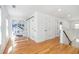 Open hallway with wood floors, white walls, natural light and a desk at 1934 Westwood Sw Ave, Atlanta, GA 30310