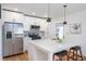 Modern kitchen featuring an island, stainless steel appliances, and elegant white cabinetry at 1934 Westwood Sw Ave, Atlanta, GA 30310