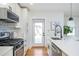 Modern kitchen with white cabinetry, stainless steel appliances, and white countertops and chevron backsplash at 1934 Westwood Sw Ave, Atlanta, GA 30310