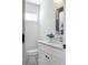 Chic powder room with white vanity, stylish mirror, and decorative floor tiles at 1934 Westwood Sw Ave, Atlanta, GA 30310