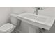 Modern half bathroom featuring white fixtures and a pedestal sink at 214 Strawberry Ln, Woodstock, GA 30189