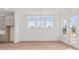 Spacious dining room with windows and glass doors leading to the outdoor space at 214 Strawberry Ln, Woodstock, GA 30189