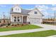 Charming home featuring a two-car garage, well-kept lawn and traditional architectural details at 214 Strawberry Ln, Woodstock, GA 30189