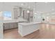 Open kitchen with center island, modern cabinetry and stainless steel vent hood at 214 Strawberry Ln, Woodstock, GA 30189