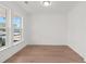 Bright living room featuring hardwood floors and a large window with natural light at 214 Strawberry Ln, Woodstock, GA 30189