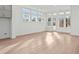 Open living room with hardwood floors, large windows offering abundant natural light at 214 Strawberry Ln, Woodstock, GA 30189