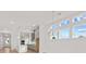 Open-concept living room with a view of the modern kitchen and large windows at 214 Strawberry Ln, Woodstock, GA 30189