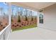 Covered patio with a backyard view and grey siding at 214 Strawberry Ln, Woodstock, GA 30189
