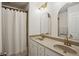 Bathroom vanity with double sinks, gold fixtures, and a modern, arched mirror at 346 Ardmore Ct, Atlanta, GA 30309