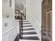 Inviting home entryway features staircase with dark wood steps and white wainscoting at 346 Ardmore Ct, Atlanta, GA 30309