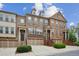 Attractive townhomes featuring brick and stone facades, front entry garages, and stairways at 346 Ardmore Ct, Atlanta, GA 30309