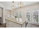 Modern kitchen features a marble island with seating, white cabinets, stainless steel appliances, and outdoor access at 346 Ardmore Ct, Atlanta, GA 30309