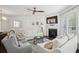Bright and airy living space with fireplace, white couches and modern ceiling fan at 346 Ardmore Ct, Atlanta, GA 30309