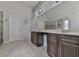 Elegant bathroom featuring a double vanity with dark wood cabinets and a large mirror at 1510 Silver Mist Cir, Powder Springs, GA 30127