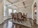 Elegant dining room with decorative molding, coffered ceiling, large windows, and a stylish chandelier creating an inviting space at 1510 Silver Mist Cir, Powder Springs, GA 30127