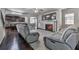 Spacious living room with a fireplace, hardwood floors, and comfortable seating, perfect for entertaining and relaxation at 1510 Silver Mist Cir, Powder Springs, GA 30127