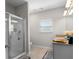 Bathroom with glass enclosed shower, tile floor, granite countertop vanity, and a window at 224 Eva Way, Cartersville, GA 30121