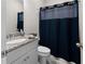 Bathroom features a vanity with granite countertop, single sink, and a blue shower curtain at 224 Eva Way, Cartersville, GA 30121