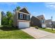 Two-story home with attached two-car garage and a lush green lawn at 224 Eva Way, Cartersville, GA 30121