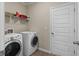 Functional laundry room with washer, dryer, and storage shelving at 224 Eva Way, Cartersville, GA 30121