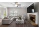 Cozy living room with a stone fireplace, plush seating, and ample natural light at 224 Eva Way, Cartersville, GA 30121