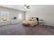Bright main bedroom with neutral walls, carpet floor, ceiling fan, and many windows providing natural light at 224 Eva Way, Cartersville, GA 30121