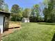 Expansive backyard featuring a deck, lush lawn, and a detached two car garage at 534 534 Shannon Way, Lawrenceville, GA 30044