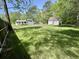 Lush green backyard with the white house and detached two car garage in background at 534 534 Shannon Way, Lawrenceville, GA 30044