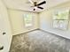 Cozy bedroom with fresh neutral walls, plush gray carpeting, and a ceiling fan at 534 534 Shannon Way, Lawrenceville, GA 30044