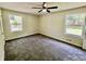 Bright bedroom showcasing two windows, neutral walls, and plush gray carpeting at 534 534 Shannon Way, Lawrenceville, GA 30044