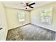 Sunlit bedroom with soft neutral walls, plush gray carpeting, and a ceiling fan at 534 534 Shannon Way, Lawrenceville, GA 30044