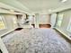 Open-concept living space featuring a carpeted living room and hardwood dining area at 534 534 Shannon Way, Lawrenceville, GA 30044