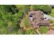 Aerial view of property featuring large wooded lot and deck with fire pit at 560 Brook Manor Dr, Johns Creek, GA 30022