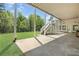 Large covered back porch with an outdoor staircase and view of green lawn at 560 Brook Manor Dr, Johns Creek, GA 30022