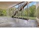 Back porch featuring a covered area with outdoor staircase leading to green lawn at 560 Brook Manor Dr, Johns Creek, GA 30022