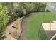 Backyard showing wooden stairs leading to lawn with mature trees and fence at 560 Brook Manor Dr, Johns Creek, GA 30022