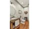 Bathroom features rustic wood vanity, accent decor, and hardwood floors at 560 Brook Manor Dr, Johns Creek, GA 30022