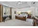Spacious bedroom boasts trey ceiling, neutral carpet, and bright natural light at 560 Brook Manor Dr, Johns Creek, GA 30022
