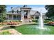 Clubhouse featuring a large water feature in a landscaped circle drive at 560 Brook Manor Dr, Johns Creek, GA 30022