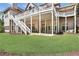 A view of the back of the house and multi-level deck with lawn at 560 Brook Manor Dr, Johns Creek, GA 30022